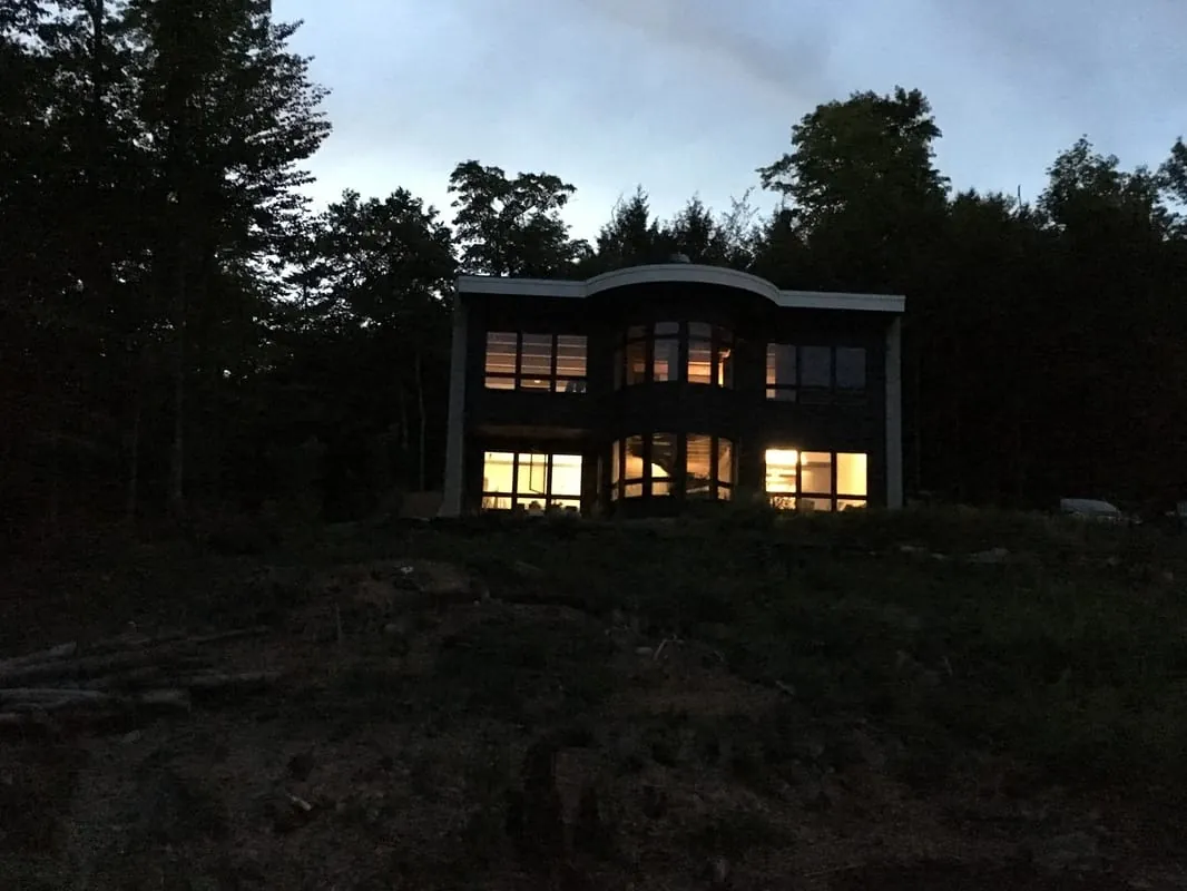 Mountain home lit from within at dusk