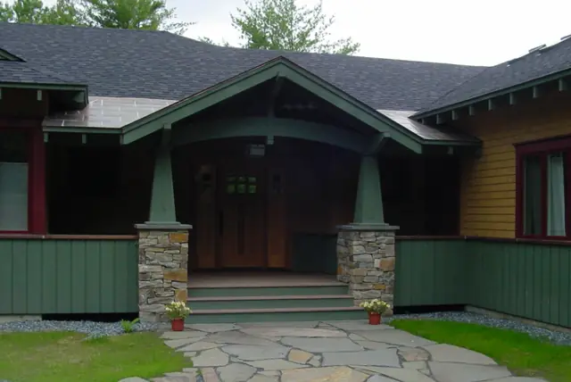 Craftsman entry porch with stone piers and tapered columns