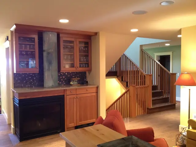 Built-in cabinetry and fireplace with a view to the stair