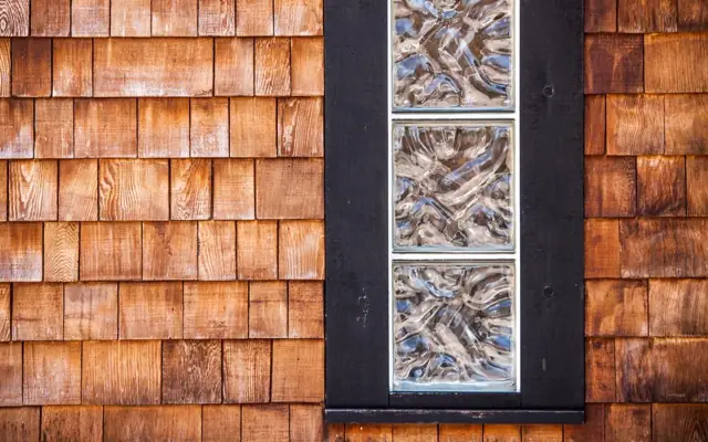 Cedar shingle wall with inset decorative tiles