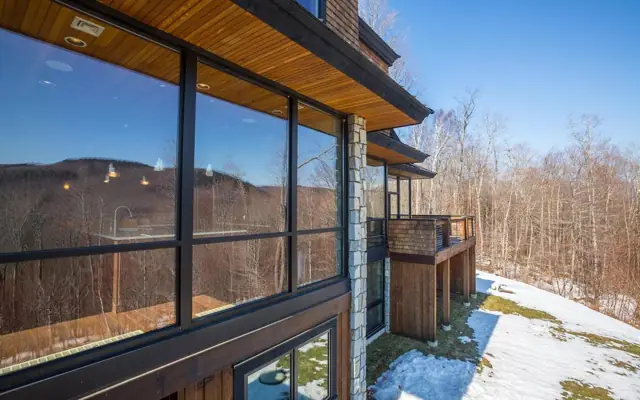 Corner of glass overlooking a forested valley