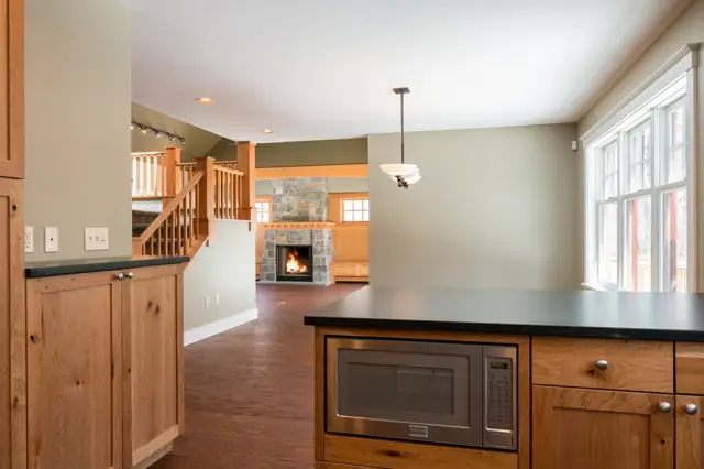 Kitchen opening to a bright living area