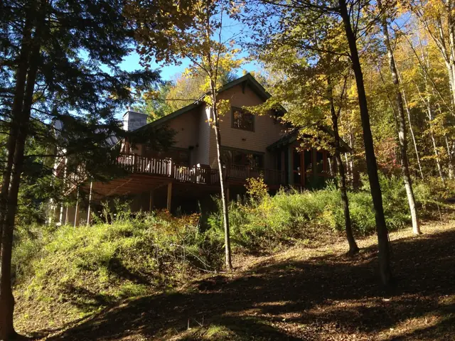 House seen through autumn woods