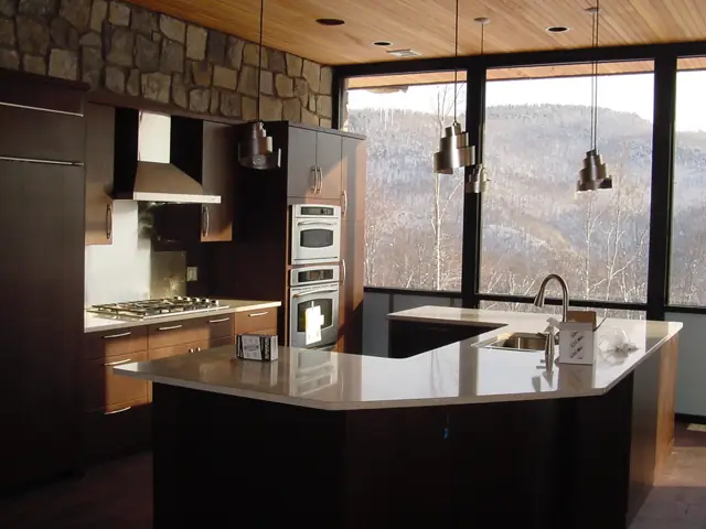 Contemporary kitchen with dark cabinetry and mountain-view windows