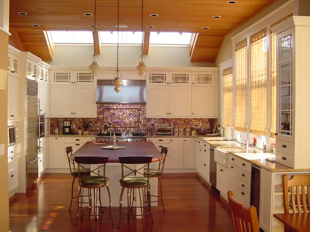 Bright kitchen with skylights and a long dining table