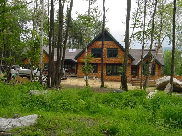 Gabled home among tall trees in spring