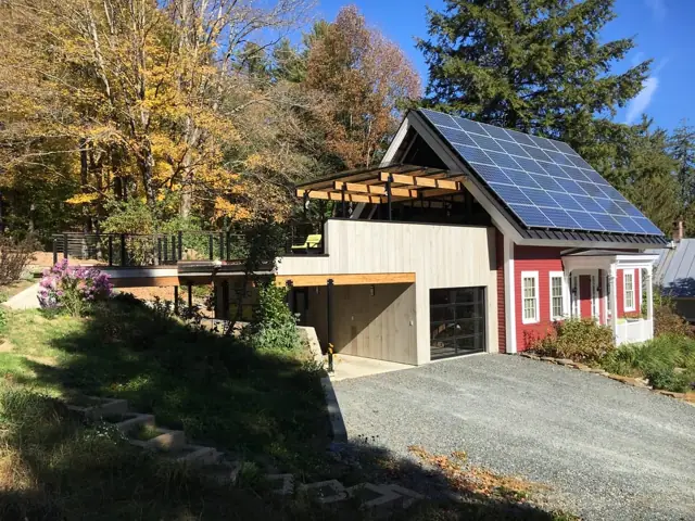 Home with solar panels and timber deck
