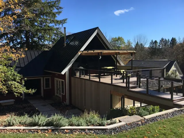 Contemporary home with standing-seam metal roof and covered deck