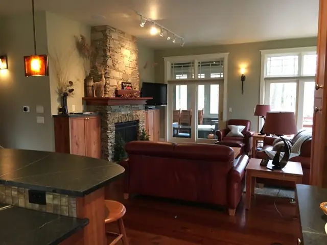 Living room with fireplace and wood-beamed ceiling